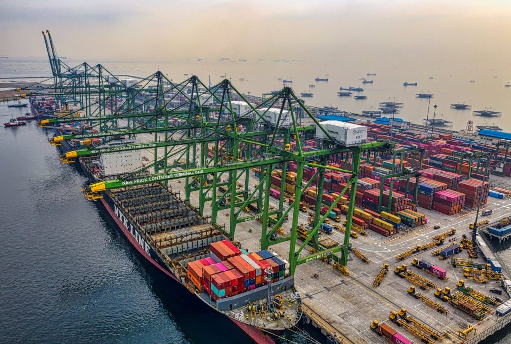 harbor-and-container-ship-moored-in-3848787 Busy cargo port in North Jakarta with cranes and container ships under a hazy sky.